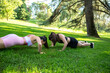 © luisrojasstock - couple young caucasian girls practicing push-ups in a park on a sunny day