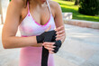 © luisrojasstock - detail young caucasian woman boxer putting bandages on her hands