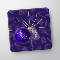 Wall Mural - Christmas Gift Box Realistic Vector Template. Paper Wrapped Container with Greetings Tag and Toy Ball. Holiday Packaging Design Illustration. Hand Drawn New Year Background Seamless Pattern. Isolated