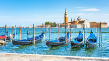Moored Gondolas At St. Mark Square With Church Of San Giorgio Maggiore On Background. Venice, Italy
