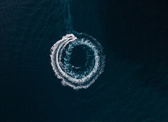 Wall Mural - Aerial view of a motorboat sailing on the sea and making splashes