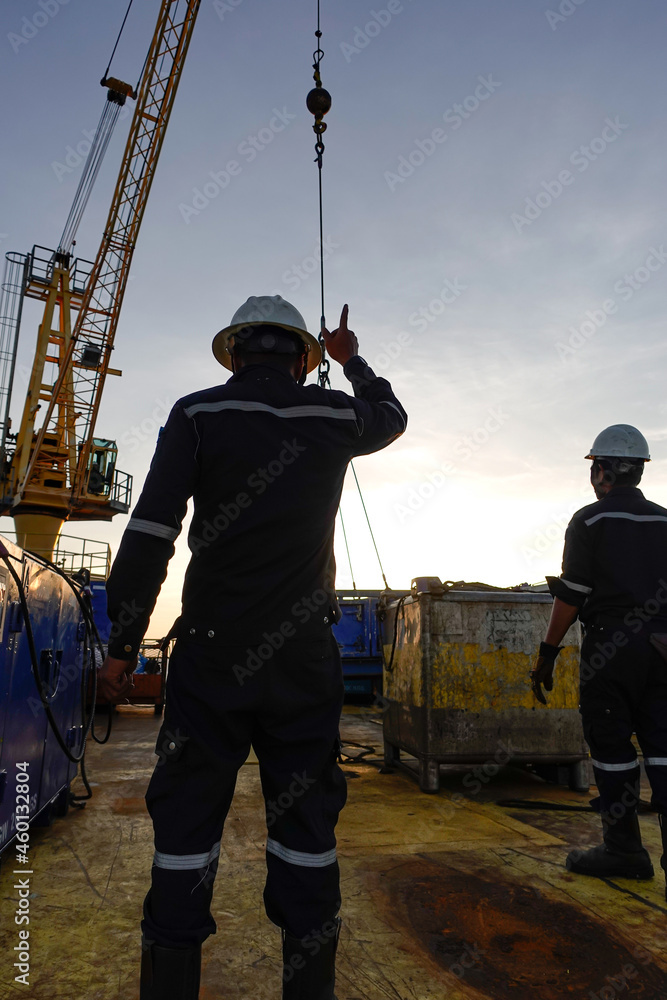 Man Riding Signal Rig Floor Rigger standing raising using a hand signal by moving finger slowly to ...