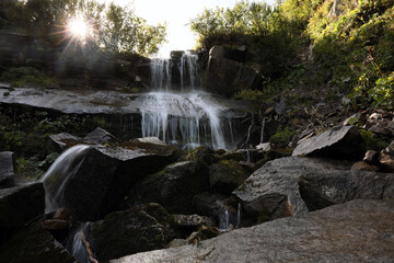 Picturesque view of mountain waterfall and green plants