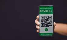 Vaccinated Person Or Hand Holding Mobile Phone With Digital Health Passport For Travel During Covid-19 Pandemic. Green Certificate, Qr Code