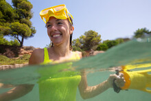 Spain, Mallorca, Smiling Woman In Scuba Mask In Sea
