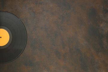  Vinyl record on a stone background. Retro style. Top view.