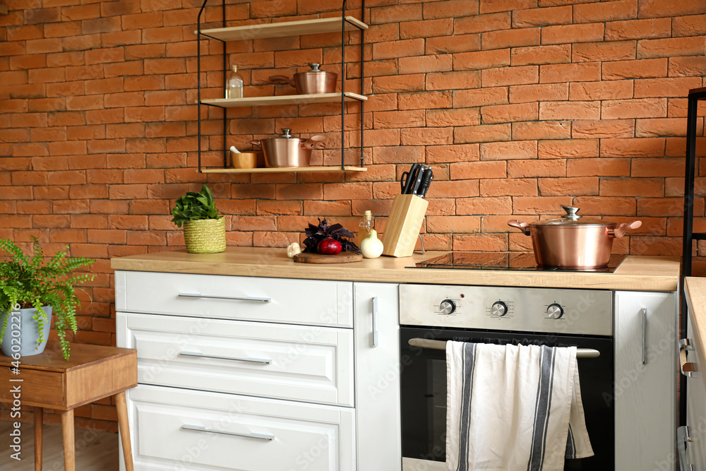 Interior of stylish kitchen with modern cookware