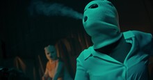 A Sexy Criminal Woman Wearing A White Facemask And Smoking A Cigarette In A Dark Room Shot In 4K