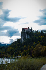 Sticker - Old house on the edge of a cliff near the lake on a cloudy day