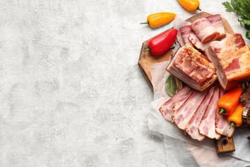 Wall Mural - Wooden board with tasty smoked bacon and fresh vegetables on light background, closeup