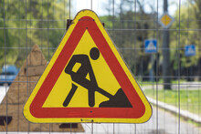 Road Works Sign Denoting Construction Work. Construction Site. Restoration And Reconstruction Concept. Traffic Barrier.