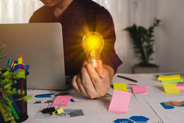 Wall Mural - holding light bulb, new idea with innovation concept