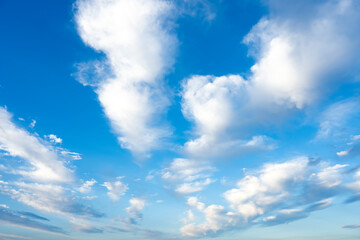 Wall Mural - Stunning view of some white clouds moving across a blue sky. Natural background, Sardinia, Italy.