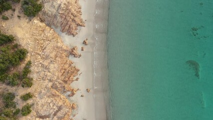 Wall Mural - View from above, stunning aerial view of a rocky coastline with a white sand beach bathed by a turquoise, crystal clear water. Liscia Ruja, Costa Smeralda, Sardinia, Italy..