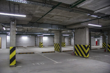 Wall Mural - Empty parking place in a residential building. Covered underground parking for cars