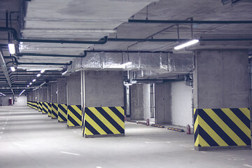 Wall Mural - Empty parking place in a residential building. Covered underground parking for cars