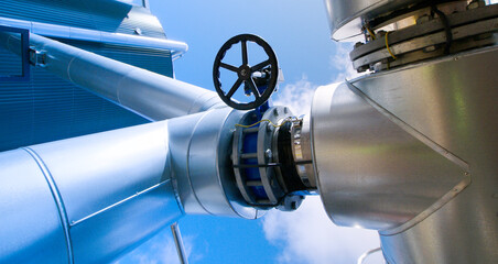 Wall Mural - Industrial zone, Steel pipelines and valves against blue sky