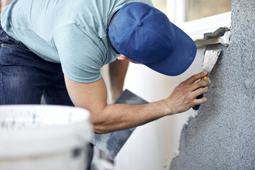 Wall Mural - Man working on a house facade.