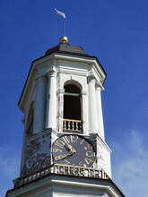 The Upper Tier Of The Clock Tower, A Former Bell Tower With A Dome, Clock And Weather Vane Against The Blue Sky.