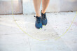 © luisrojasstock - detail sneakers young woman athlete jumping rope