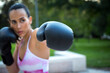 © luisrojasstock - defocused young athlete woman training boxing with gloves giving a punch