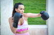 © luisrojasstock - young athlete woman training boxing with gloves giving a crochet