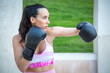 © luisrojasstock - young athlete woman training boxing with gloves giving a crochet
