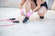 © luisrojasstock - young athlete woman tying shoelaces outdoor