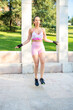 © luisrojasstock - young sporty woman skipping rope on the street
