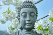 The face of Buddha. Buddha statue under the flowering cherry tree