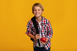 © Prostock-studio - Positive european teenager boy pupil with backpack holding red apple, sharing and look at camera