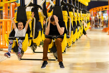 Father And Daughter On Amusement Park Roller Coaster