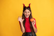 evil child in imp horns. happy halloween. devil kid with pumpkin. trick or treat.