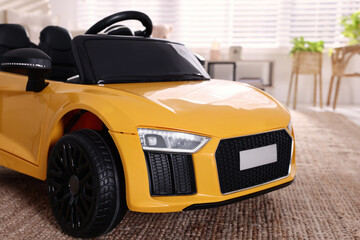 Poster - Yellow car in room at home, closeup. Child's toy