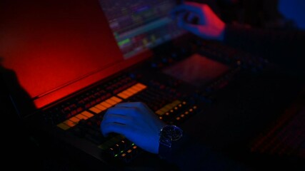 Wall Mural - Hand of a light designer on the mixing light console during a concert.