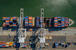 © Cavan Images - Aerial view of a cargo ship loading at the port