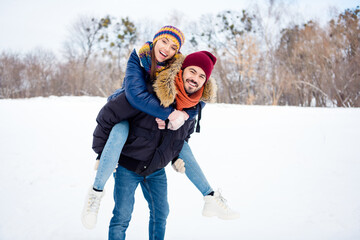 Poster - Portrait of cheerful glad man hold on back positive adorable girl toothy smile look camera have good mood outdoors