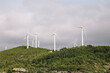 © Cavan Images - Windmills In Field Against Cloudy Sky