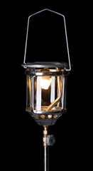 Wall Mural - Vintage gasoline oil lantern lamp burning with a soft glow light on a black background