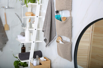 Canvas Print - Knitted organizer hanging on wall in bathroom