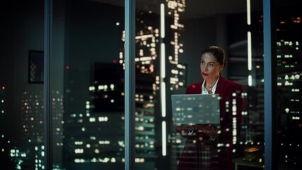 Wall Mural - Successful Businesswoman in Stylish Suit Working, on Laptop Looking in Wonder at Night City. Stylish Beautiful Female CEO Working Late on Computer to Achieve Best Results. Colorful Cinematic Portrait