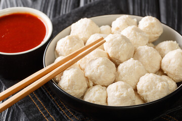 Wall Mural - Recipe Yummy Chicken Meat Balls Bakso Ayam with sauce close up in the bowl on the table. Horizontal