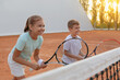 © New Africa - Happy children playing tennis on court outdoors