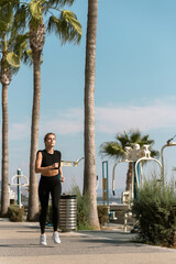 Wall Mural - Athletic woman is running during her summer jogging workout