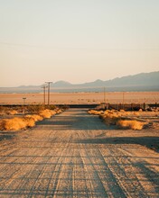 Dirt Street With Mountains In The Distance In Amboy, On Route 66 In The Mojave Desert Of California