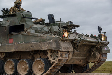 British army Warrior FV512 mechanized recovery vehicle tank in action on military battle exercise, Wiltshire UK 