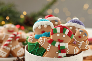 Wall Mural - Delicious homemade Christmas cookies in bowl against blurred festive lights, closeup