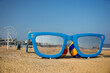 03 September 2021, Scheveningen beach, The Hague, Netherlands, model of  cun glasses on the sand with beach balls