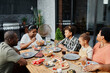 © Seventyfour - Portrait of big African-American family sitting at table and enjoying dinner together outdoors, copy space