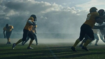 Wall Mural - American Football Field Two Teams Compete: Successful Player Jumping Over Defense Running to Score Touchdown Points. Professional Athletes Compete for the Ball, Tackle, Fight for Championship Victory